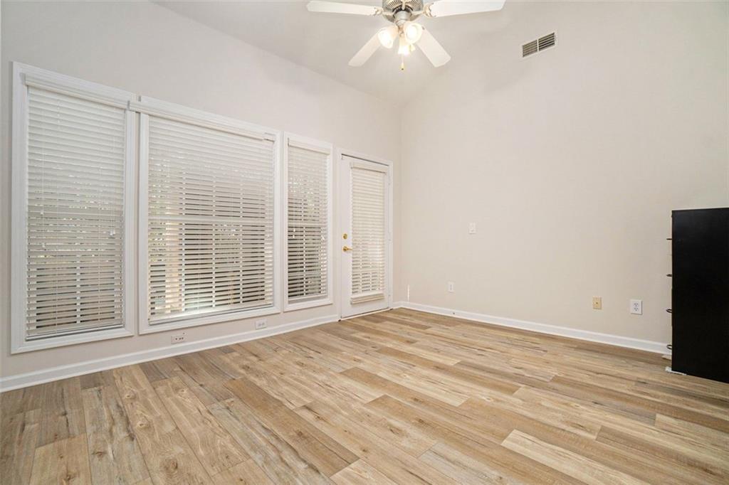 3233 Abbott Drive Southwest, Unit 7 Powder Springs, GA 30127 - Photo 22 of 24 a view of an empty room with a window and wooden floor