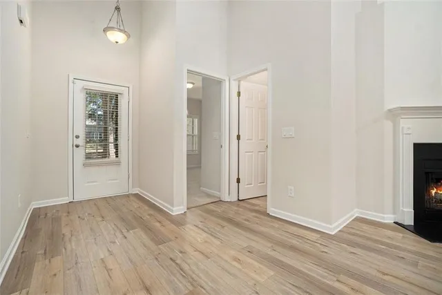 a view of a room with wooden floor and a fireplace