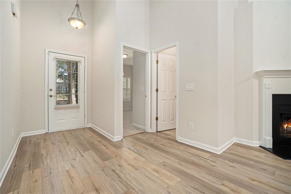 3233 Abbott Drive Southwest, Unit 7 Powder Springs, GA 30127 - Photo 5 of 24 a view of a room with wooden floor and a fireplace