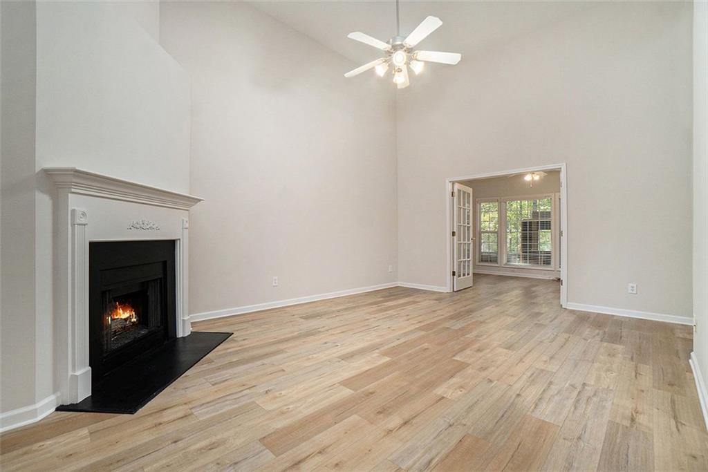 3233 Abbott Drive Southwest, Unit 7 Powder Springs, GA 30127 - Photo 6 of 24 a view of empty room with wooden floor and fireplace