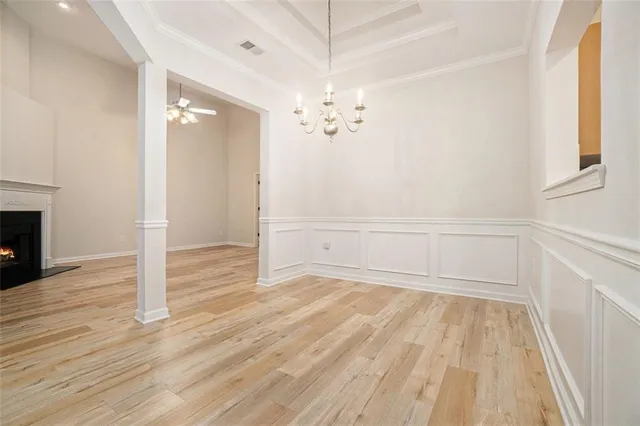 a view of a room with wooden floor and a ceiling fan