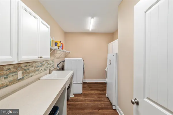 a living room with furniture and painting on the wall