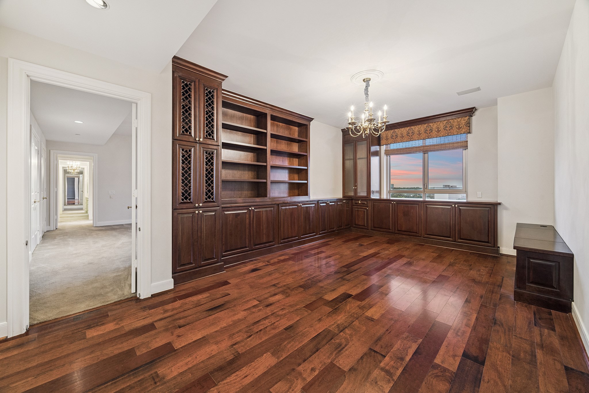 1100 Uptown Park Boulevard, Unit 102 Houston, TX 77056 - Photo 13 of 33 wooden floor chandelier and windows in a room