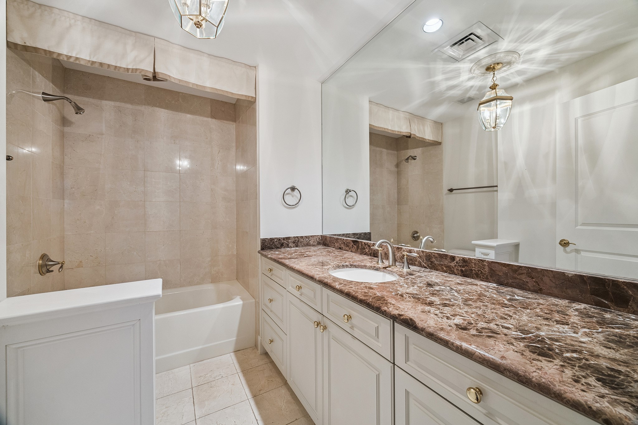 1100 Uptown Park Boulevard, Unit 102 Houston, TX 77056 - Photo 14 of 33 a bathroom with a granite countertop sink mirror and a bath tub