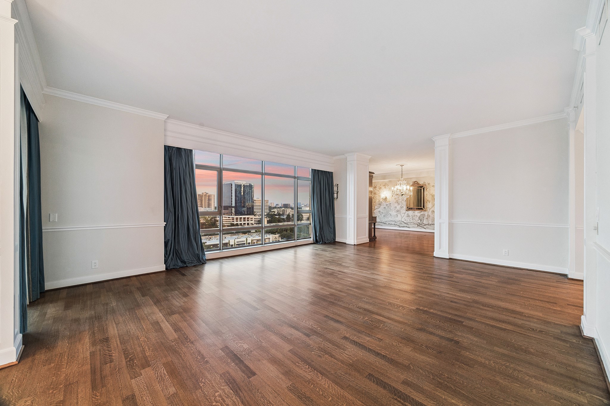 1100 Uptown Park Boulevard, Unit 102 Houston, TX 77056 - Photo 4 of 33 a view of a livingroom with wooden floor and a flat screen tv