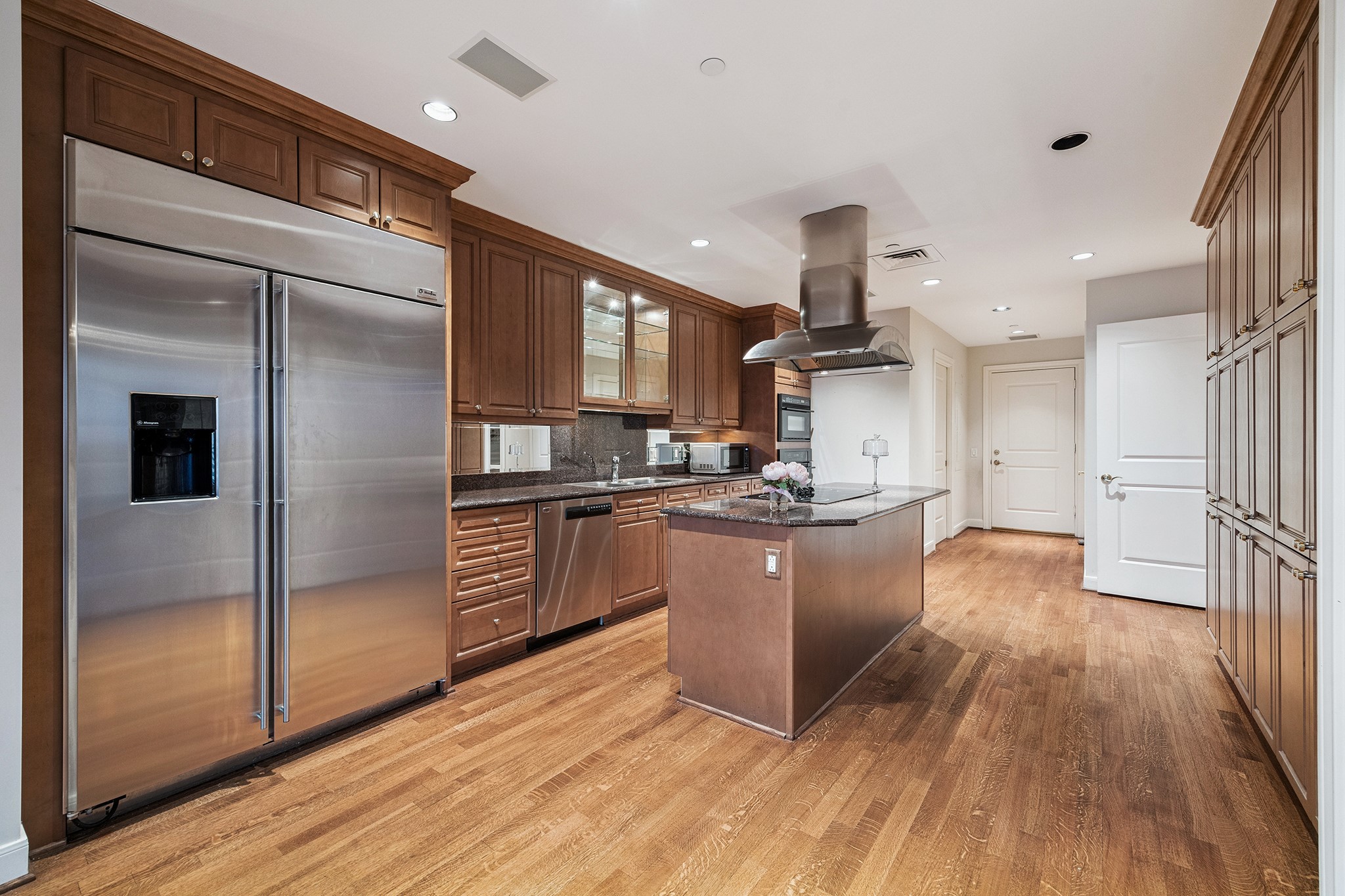 1100 Uptown Park Boulevard, Unit 102 Houston, TX 77056 - Photo 6 of 33 a kitchen with stainless steel appliances granite countertop a refrigerator and a stove top oven