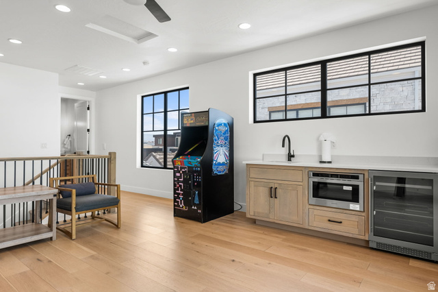 5354 Cyan Lane St. George, UT 84790 - Photo 17 of 45 Bar area featuring light wood finish cabinets, beverage cooler, recessed lighting, and light wood-type flooring