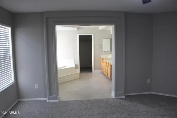 a view of a livingroom with a ceiling fan and window