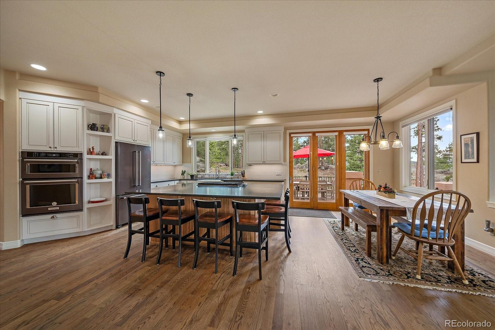 6737 Timbers Drive Evergreen, CO 80439 - Photo 11 of 47 a view of a dining area with furniture window and wooden floor