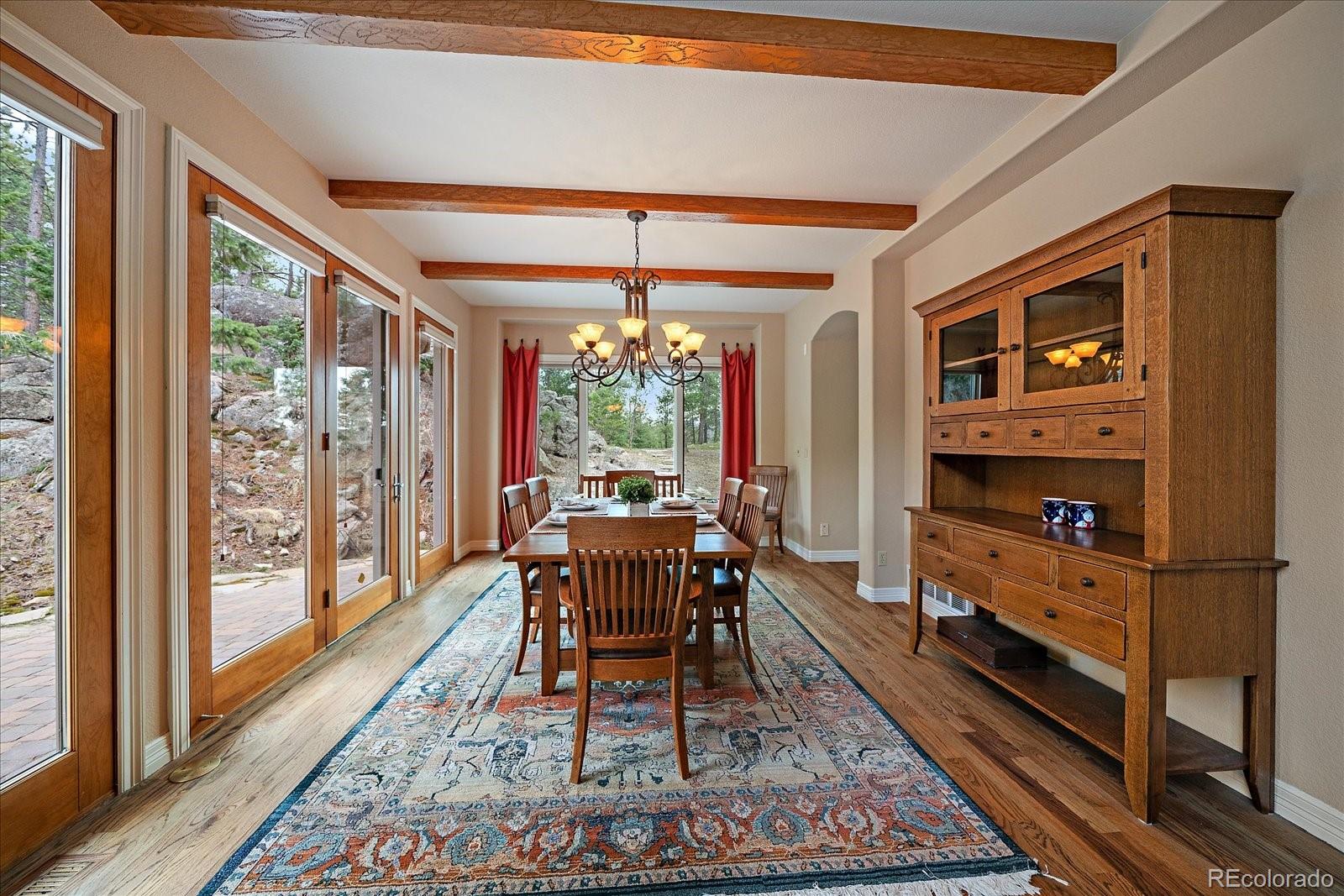 6737 Timbers Drive Evergreen, CO 80439 - Photo 16 of 47 a dining room with furniture and wooden floor