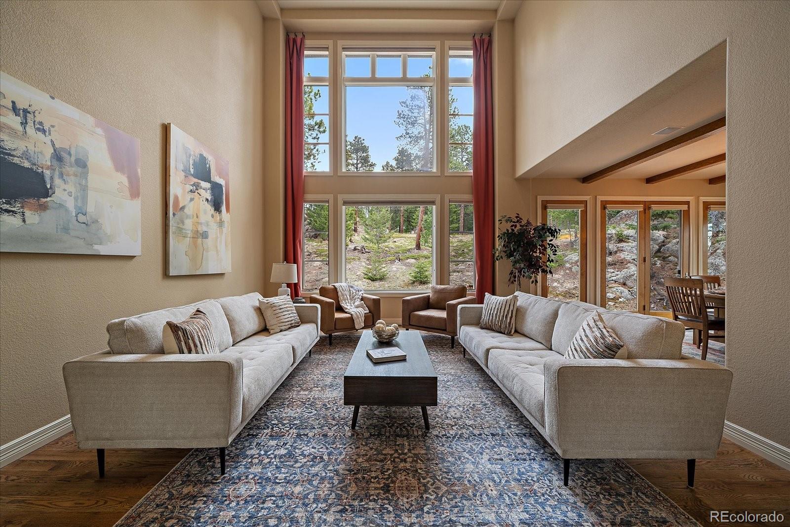 6737 Timbers Drive Evergreen, CO 80439 - Photo 17 of 47 a living room with furniture and a large window