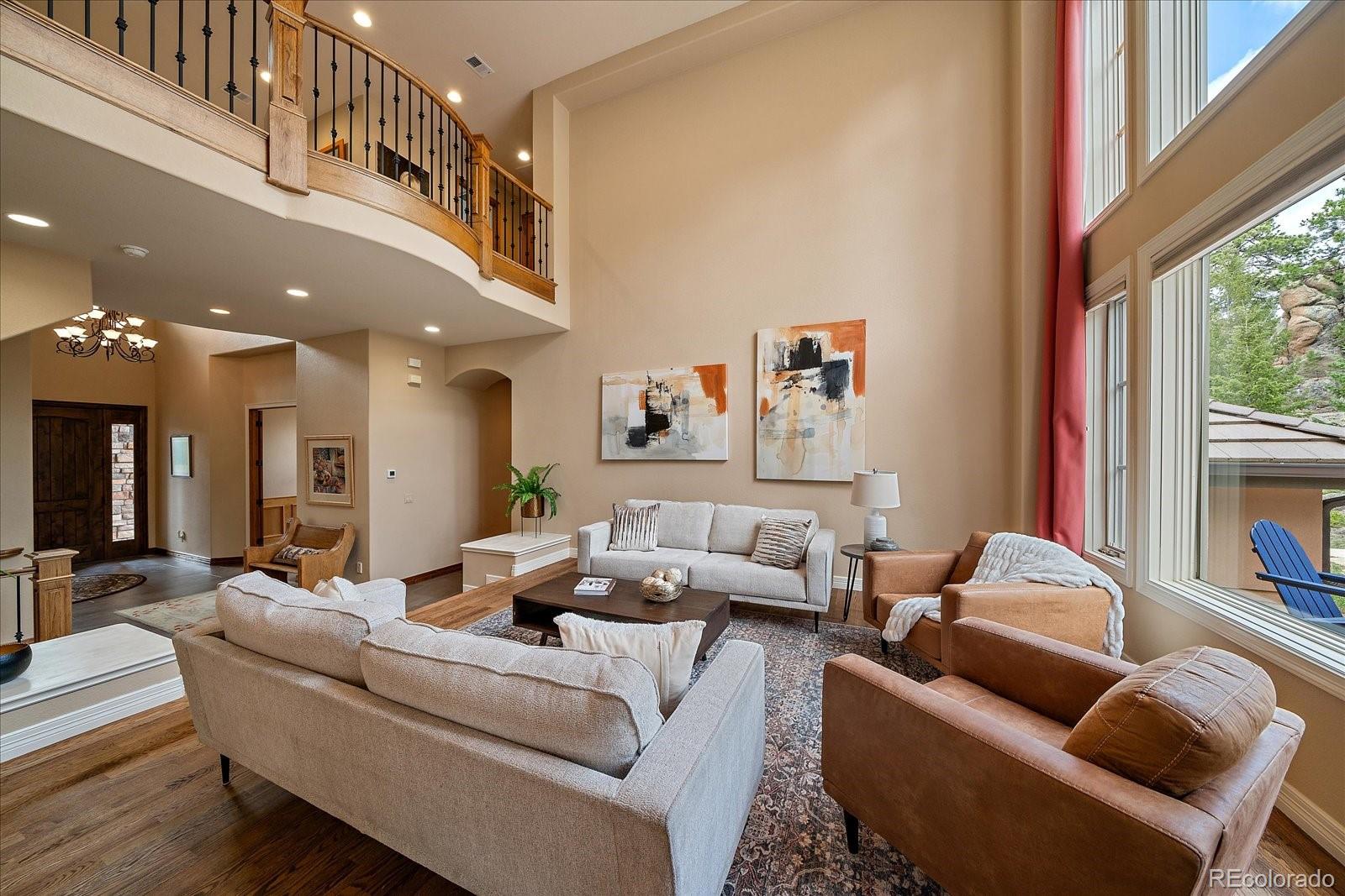 6737 Timbers Drive Evergreen, CO 80439 - Photo 18 of 47 a living room with furniture and a large window