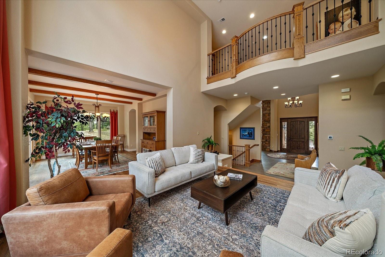 6737 Timbers Drive Evergreen, CO 80439 - Photo 19 of 47 a living room with furniture and a large window