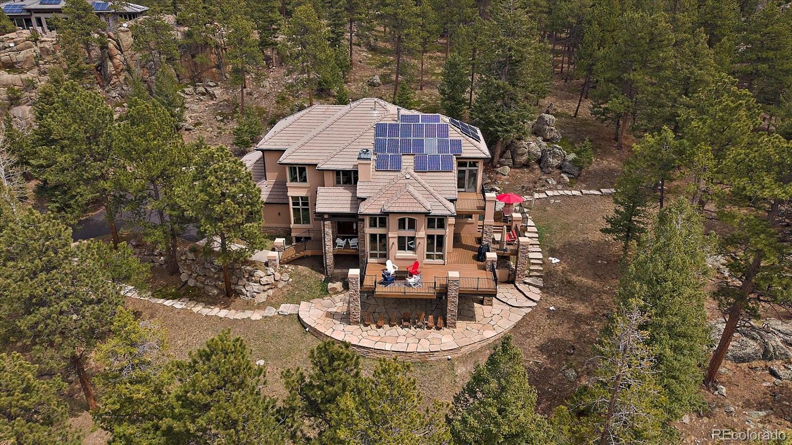 6737 Timbers Drive Evergreen, CO 80439 - Photo 2 of 47 a view of a house with roof deck and sitting area