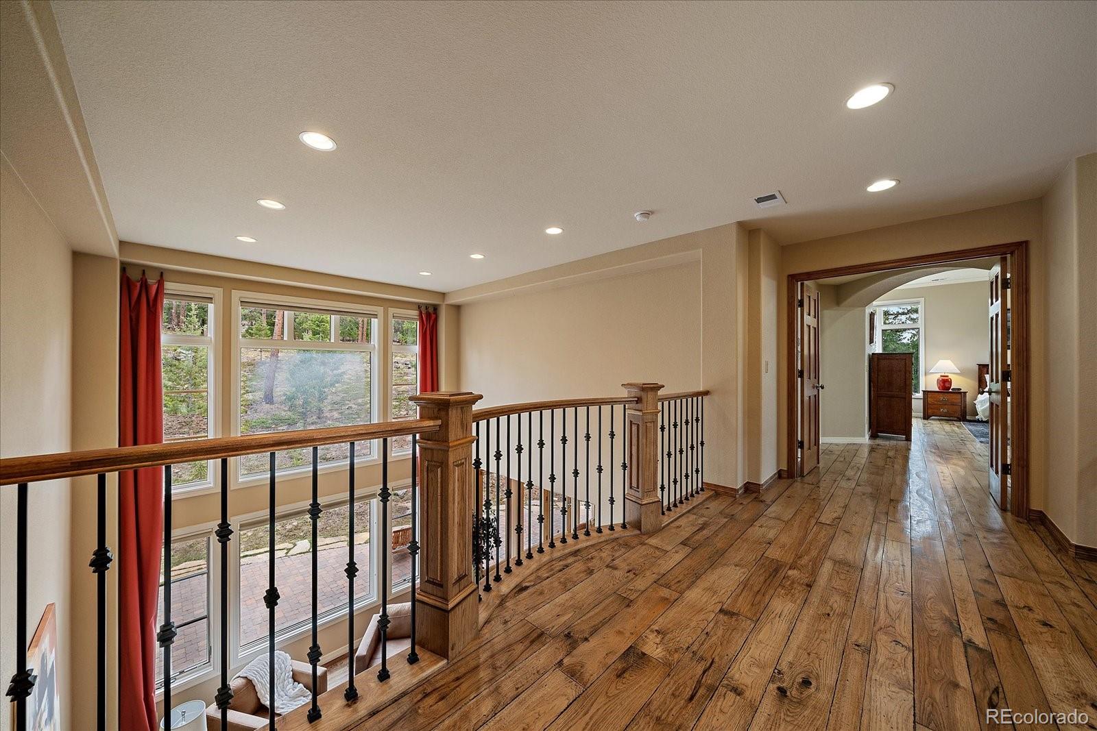 6737 Timbers Drive Evergreen, CO 80439 - Photo 22 of 47 a view of hallway with wooden floor