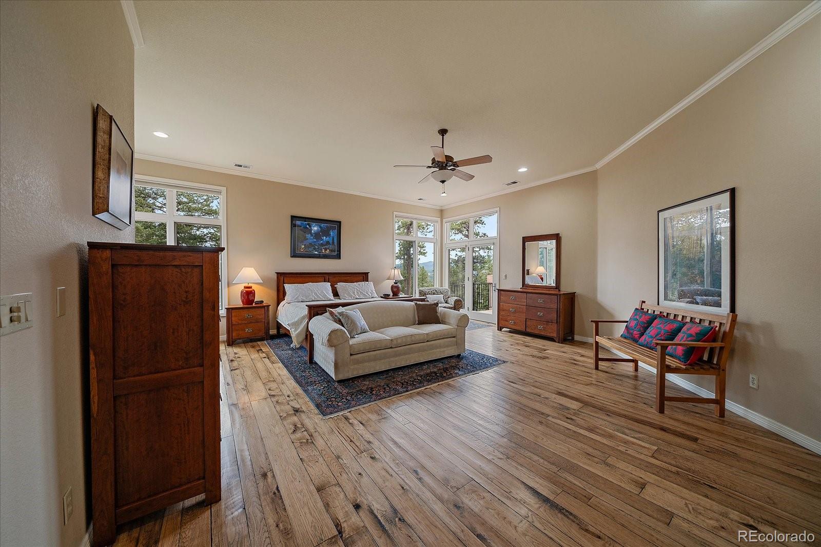 6737 Timbers Drive Evergreen, CO 80439 - Photo 23 of 47 a living room with furniture and a wooden floor