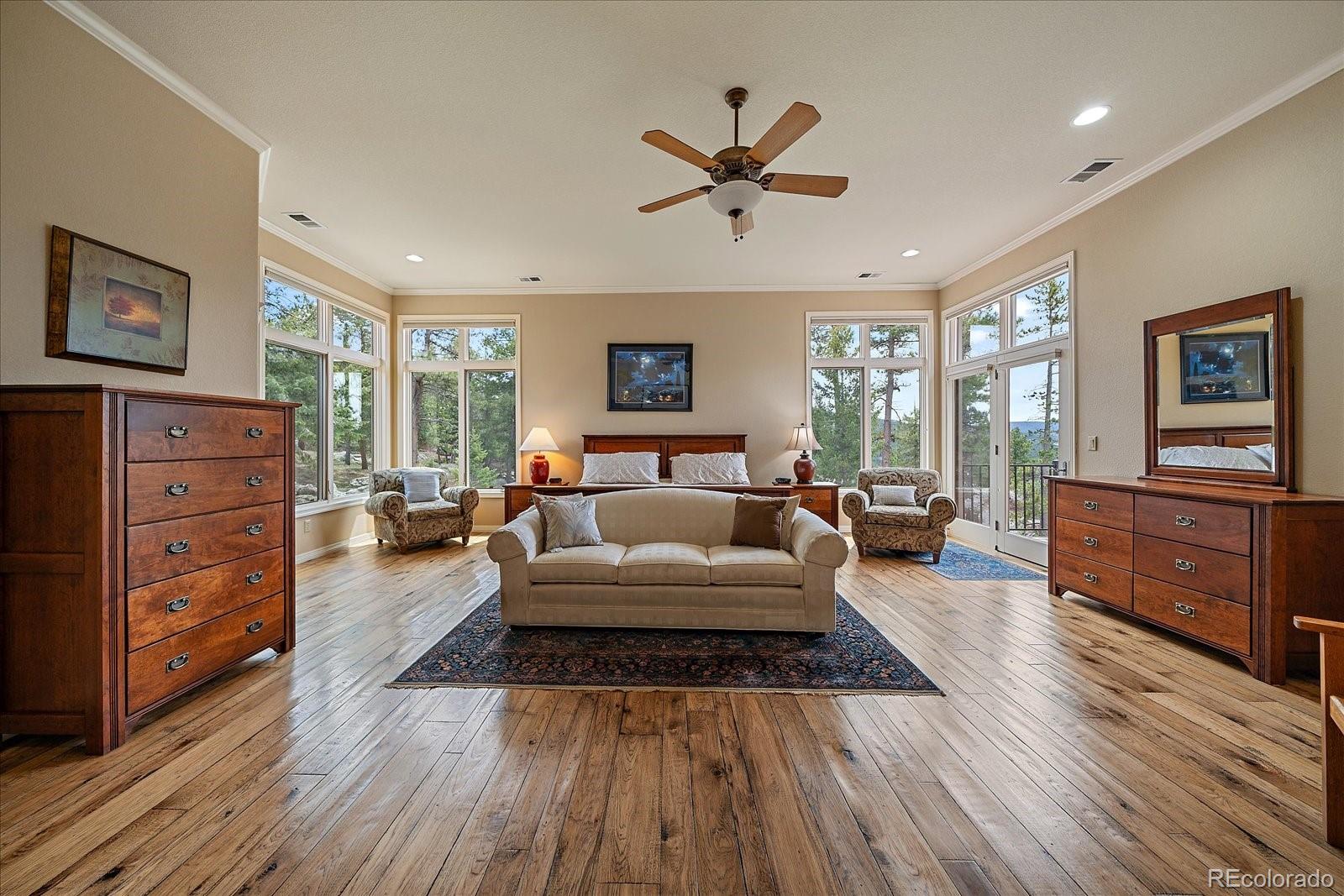 6737 Timbers Drive Evergreen, CO 80439 - Photo 24 of 47 a living room with furniture and a wooden floor