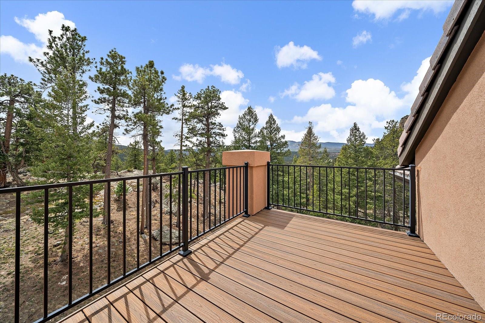 6737 Timbers Drive Evergreen, CO 80439 - Photo 27 of 47 a balcony with trees in front of it