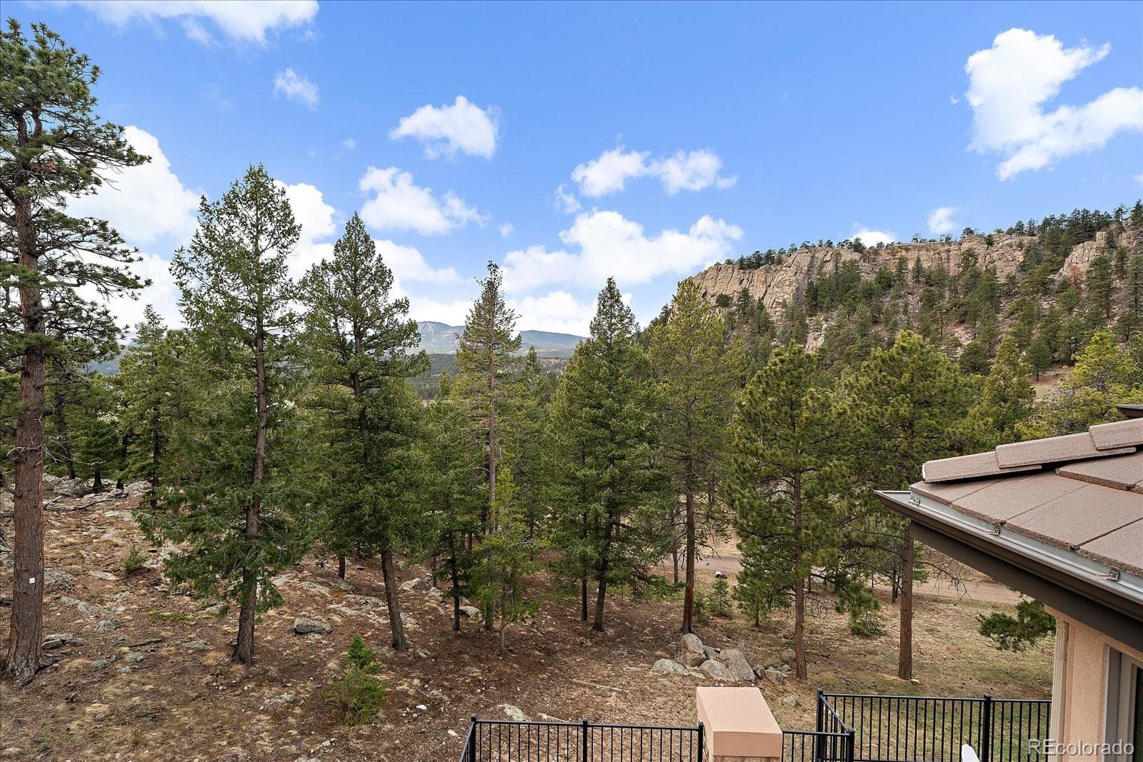 6737 Timbers Drive Evergreen, CO 80439 - Photo 28 of 47 a view of a city with tree in the background