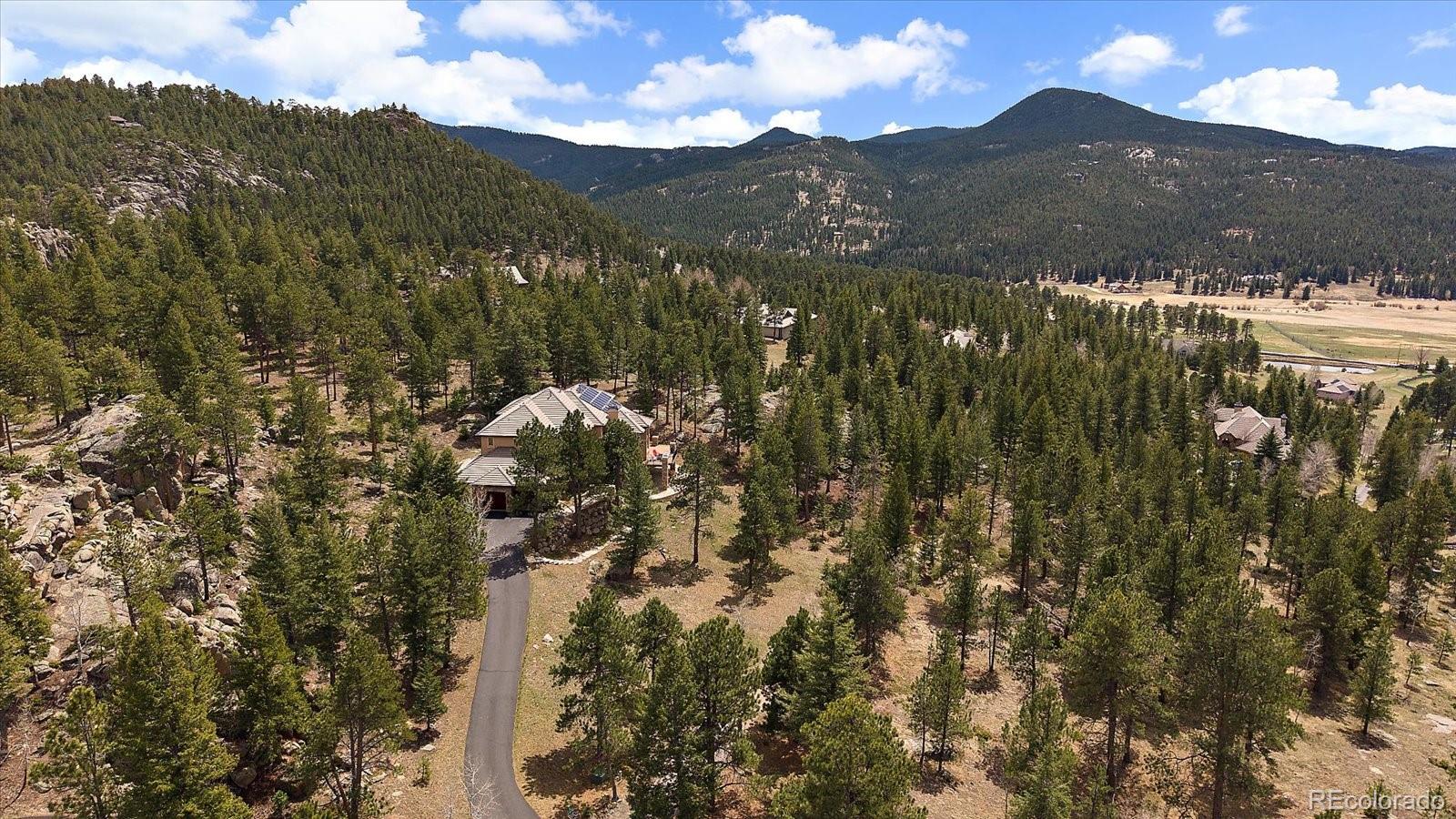 6737 Timbers Drive Evergreen, CO 80439 - Photo 3 of 47 a view of a town with mountains in the background