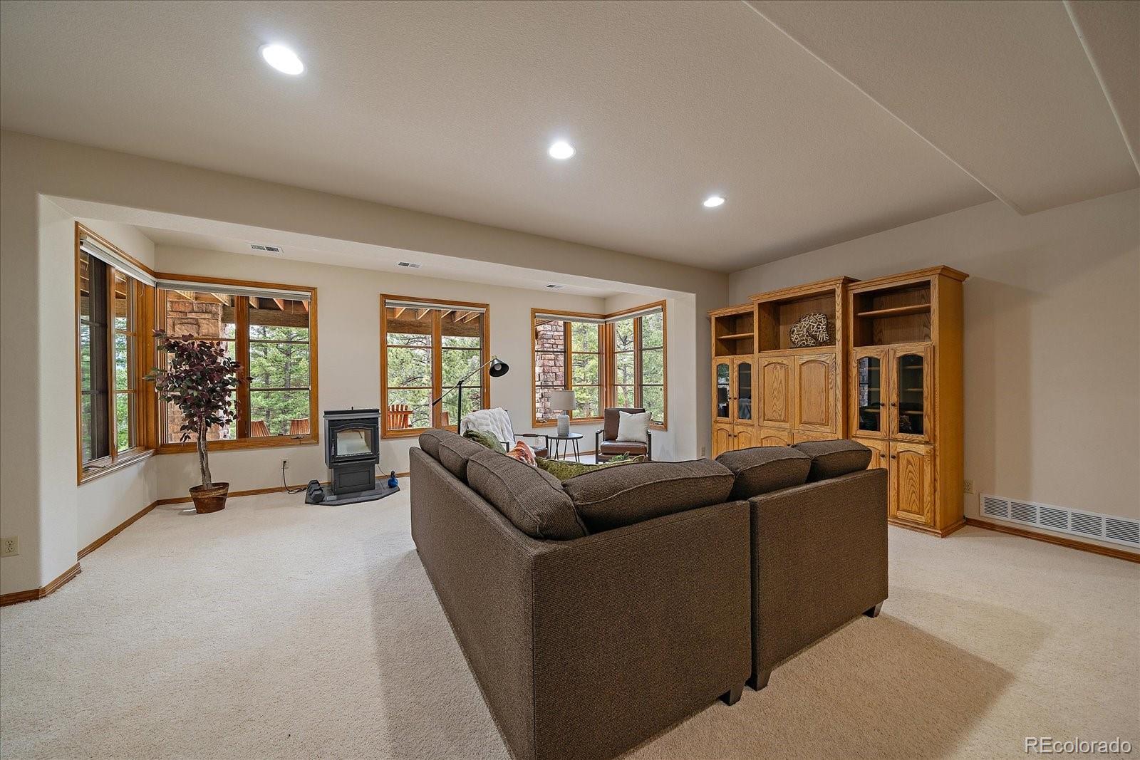 6737 Timbers Drive Evergreen, CO 80439 - Photo 33 of 47 a living room with furniture and large windows