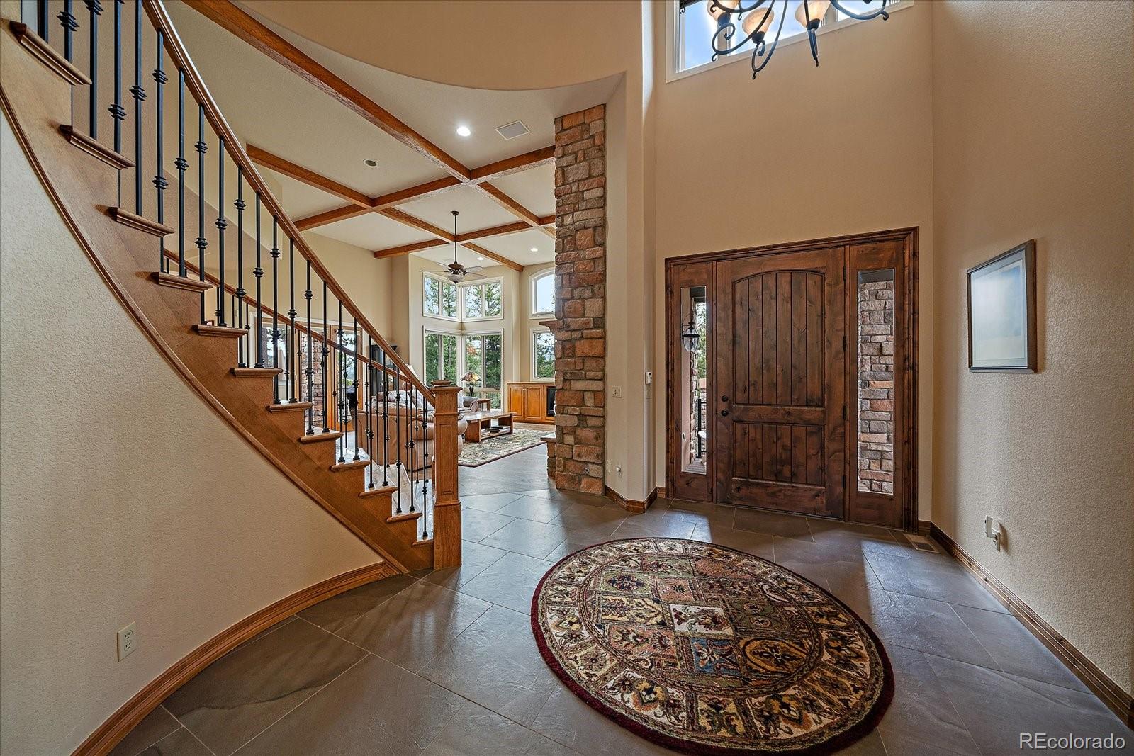 6737 Timbers Drive Evergreen, CO 80439 - Photo 4 of 47 a view of staircase with a rug and a window
