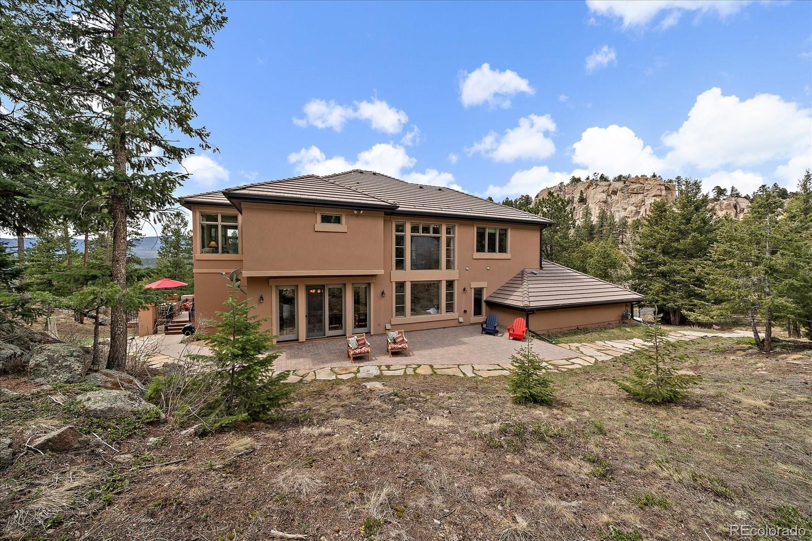 6737 Timbers Drive Evergreen, CO 80439 - Photo 41 of 47 a view of a house with a yard and hanging chair