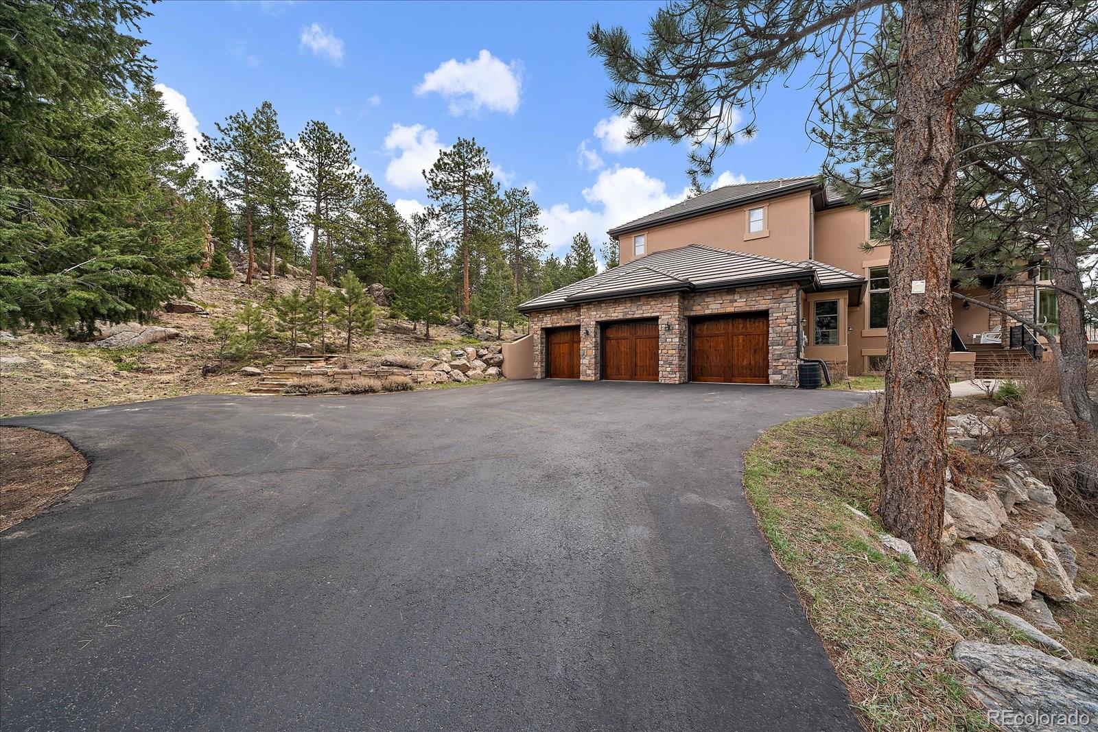 6737 Timbers Drive Evergreen, CO 80439 - Photo 42 of 47 a view of a house with a trees