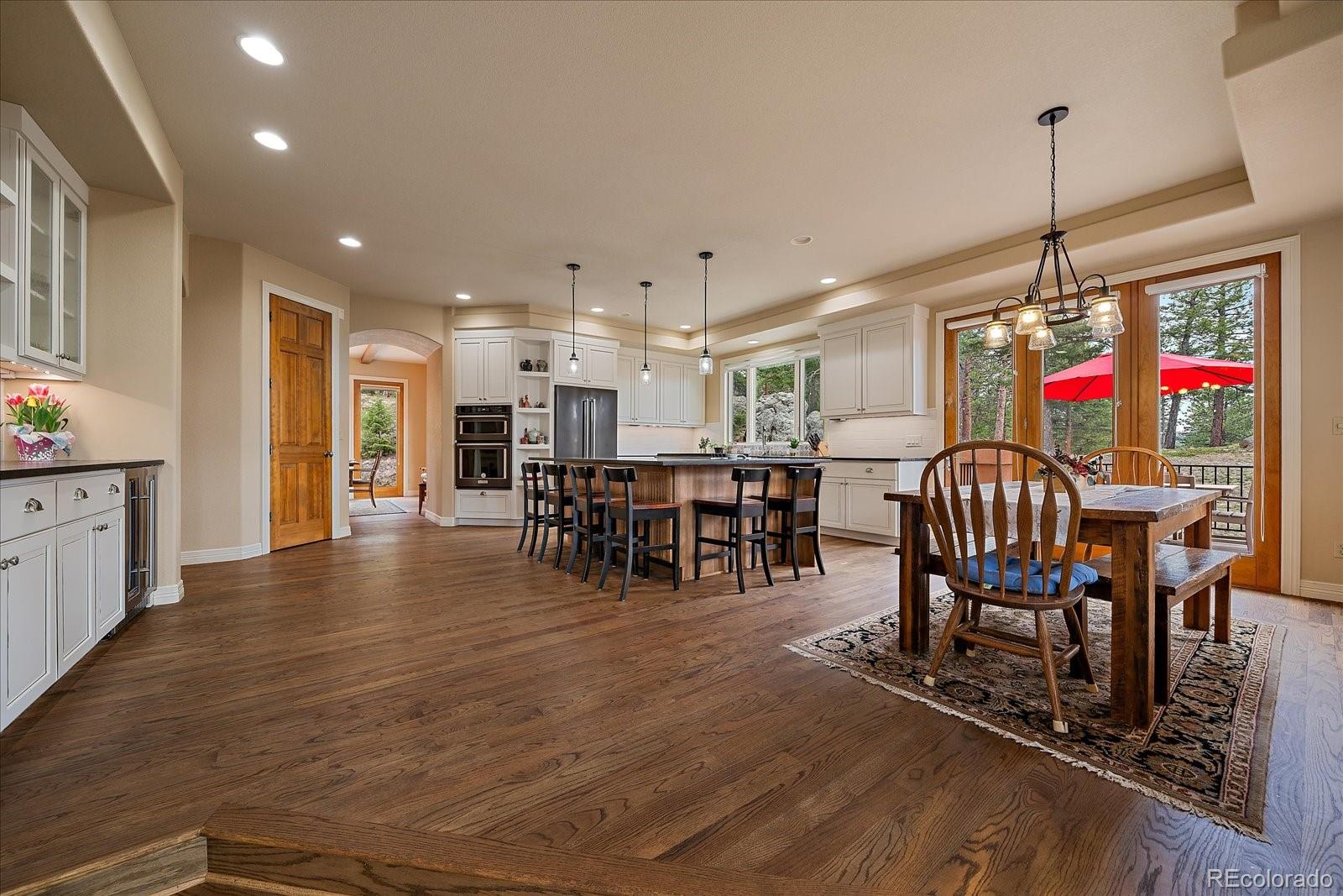6737 Timbers Drive Evergreen, CO 80439 - Photo 10 of 47 a view of a dining room with furniture and chandelier
