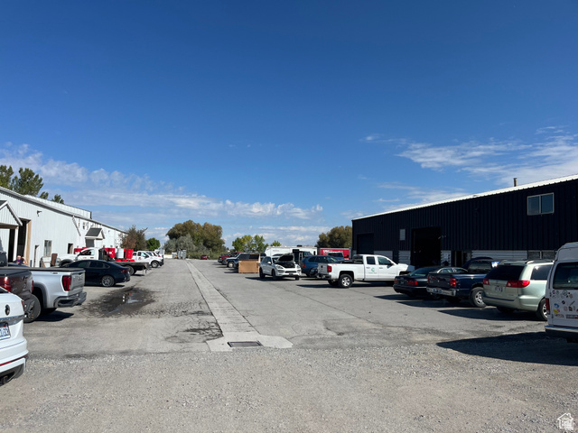 240 North 1375th Street West, Unit 3 Logan, UT 84321 - Photo 2 of 5 Expansive gravel parking area bordered by two industrial structures
