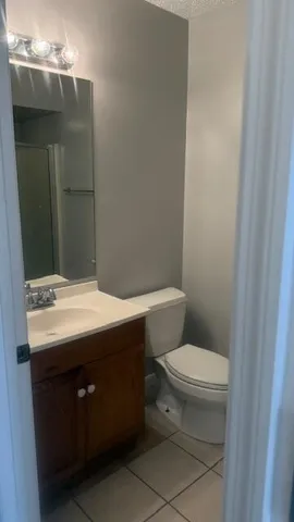a bathroom with a sink toilet and mirror
