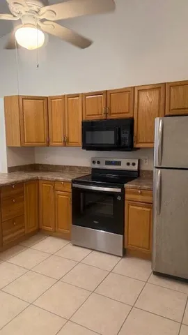 a kitchen with a stove a sink and a refrigerator