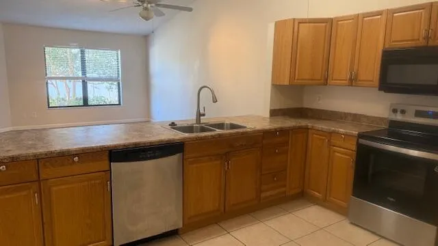 a kitchen with stainless steel appliances granite countertop a sink and a stove