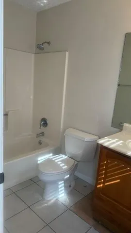 a bath room with a toilet and a bath tub