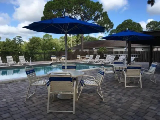 a view of a backyard with sitting area