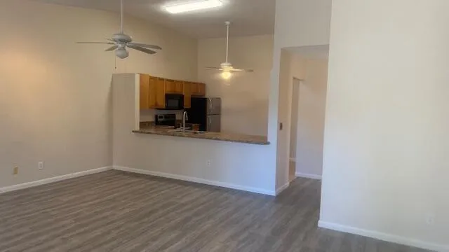 a view of a kitchen and a sink wooden floor