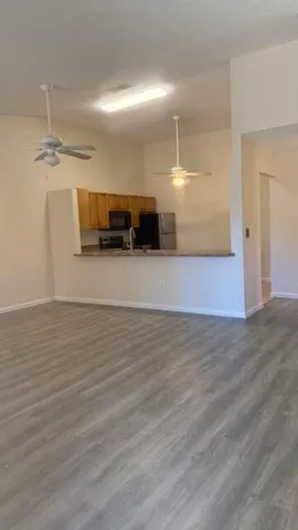 a view of a room with wooden floor