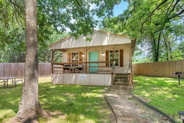 a view of a house with backyard and sitting area
