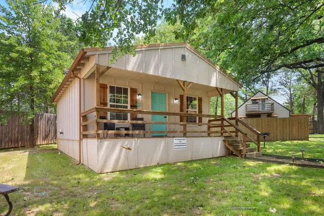 a view of a house with backyard and a tree