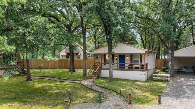 a front view of a house with a yard patio and fire pit