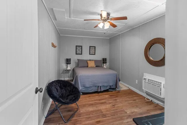 a bedroom with a bed and a large window