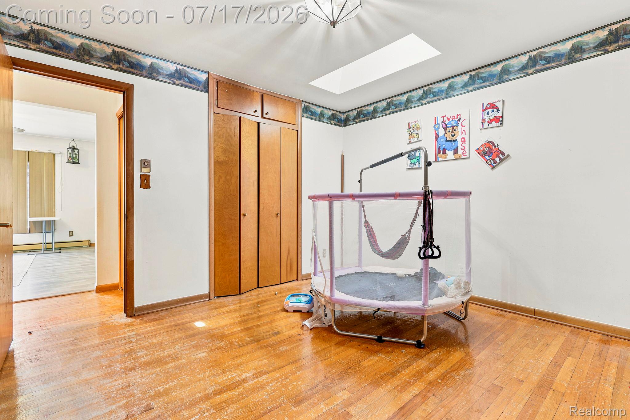 9805 Dolan Road Columbus, MI 48063 - Photo 17 of 39 Hardwood flooring throughout, recessed ceiling light fixture, and a skylight providing natural illumination