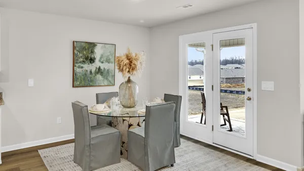 a dining room with furniture and window