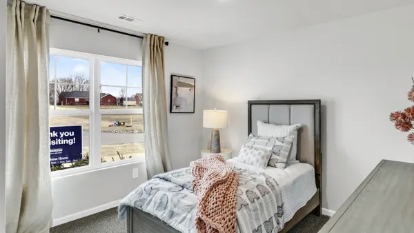 a bedroom with a bed and a mirror