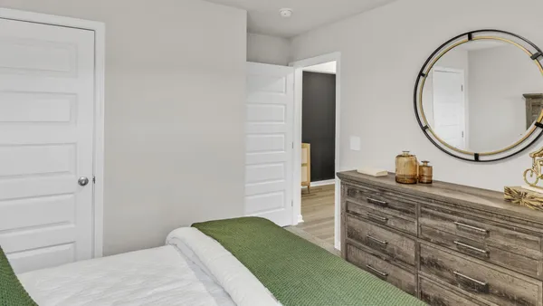 a view of bedroom with wooden floor