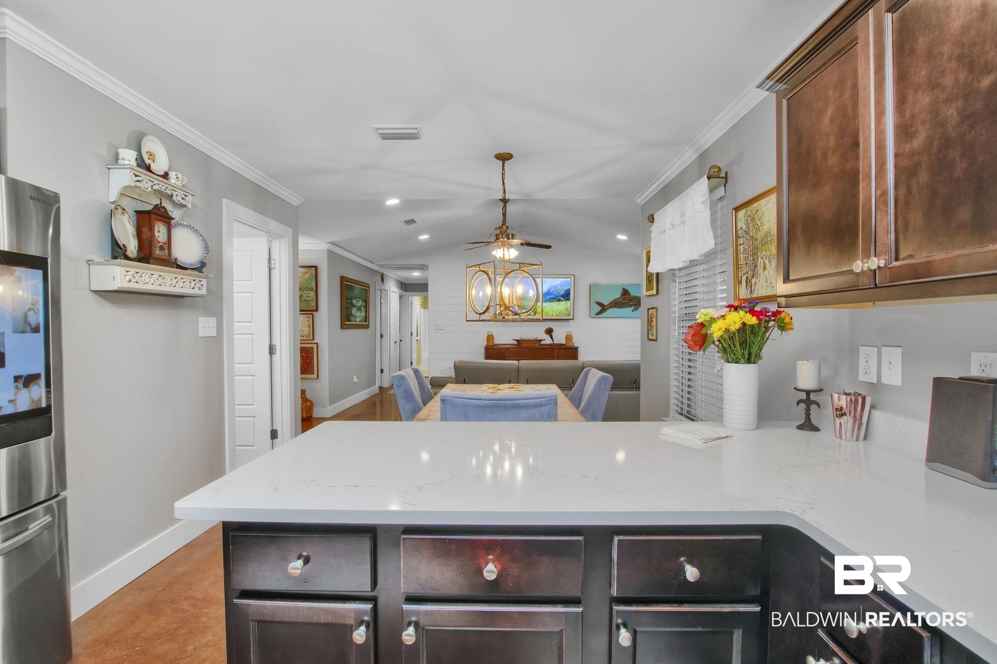 203 Lakefront Circle Summerdale, AL 36580 - Photo 28 of 69 Kitchen featuring light stone counters, lofted ceiling, kitchen peninsula, stainless steel refrigerator, and ornamental molding