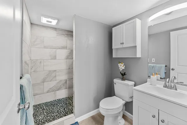 a bathroom with a sink toilet and shower
