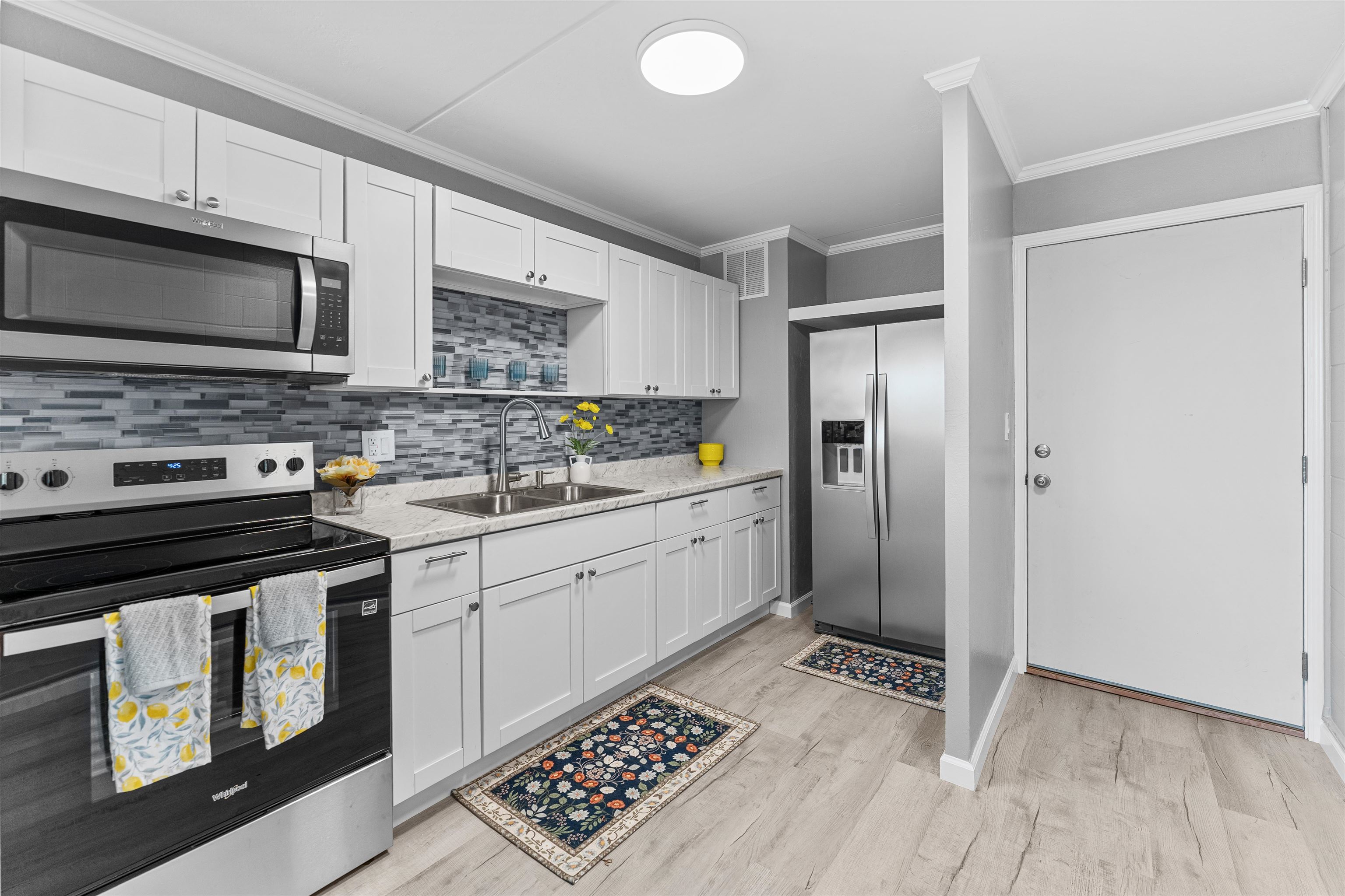 111 Kahului Beach Road, Unit D309 Kahului, HI 96732 - Photo 2 of 26 a kitchen with stainless steel appliances granite countertop a stove a refrigerator and a microwave