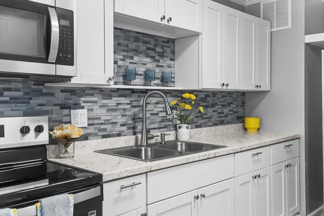 a kitchen with a sink and cabinets