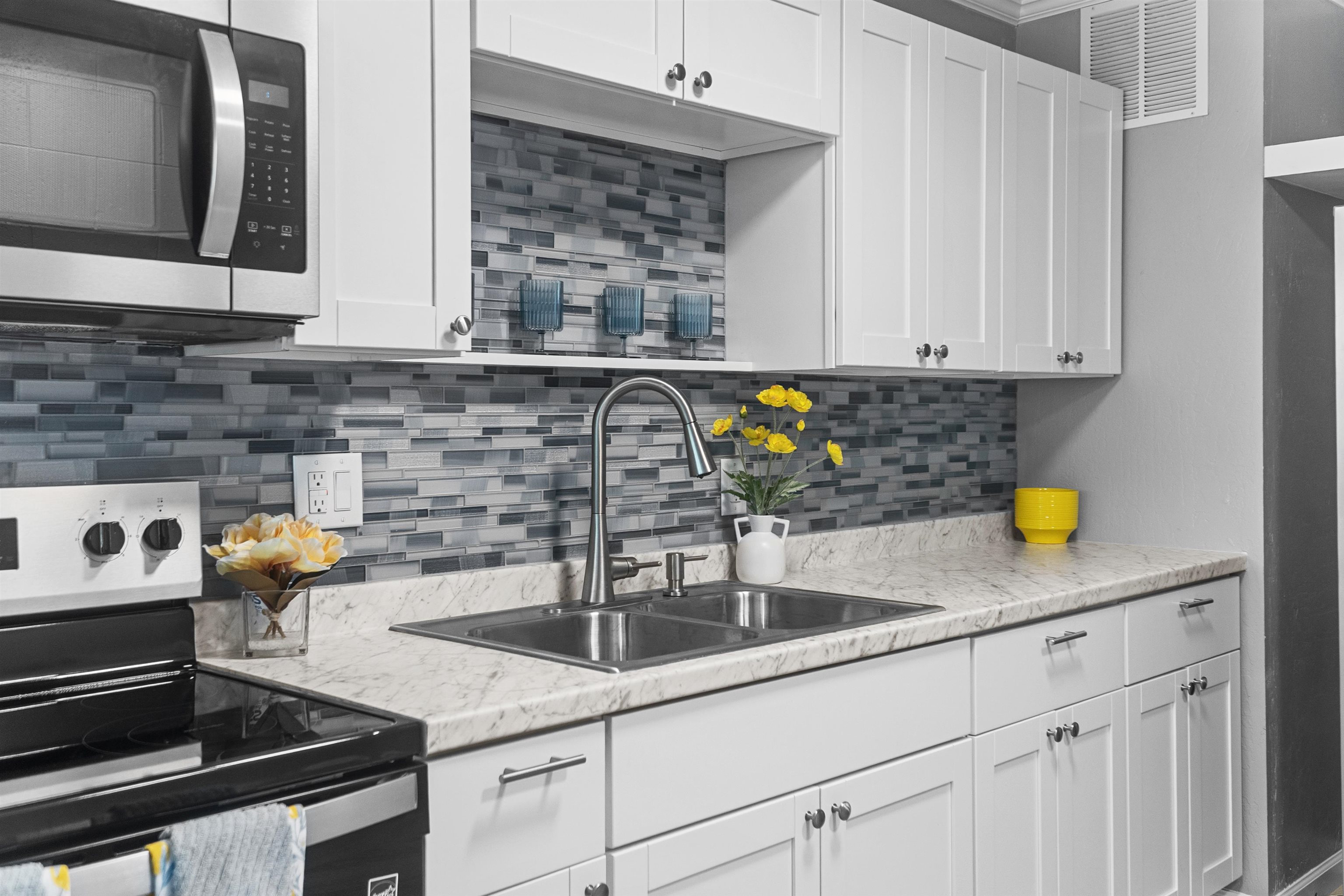 111 Kahului Beach Road, Unit D309 Kahului, HI 96732 - Photo 5 of 26 a kitchen with a sink and cabinets